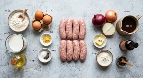 Pork sausages, flour, eggs, milk, mustard powder, onions and beef stock for toad in the hole with onion gravy