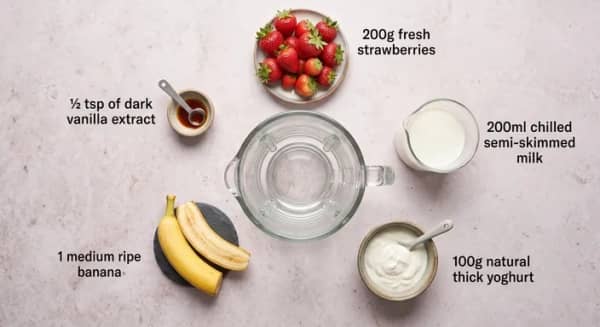 Strawberries, ripe banana, milk, natural yoghurt and vanilla extract for a strawberry banana smoothie
